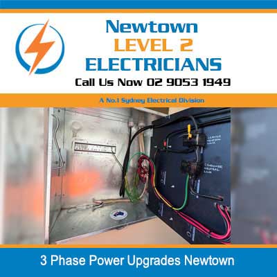 Open 3 phase power electrical panel showing internal wiring and circuit breakers during upgrade in Newtown