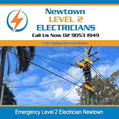 Emergency level 2 electrician in elevated platform performing emergency repairs on overhead power lines in Newtown