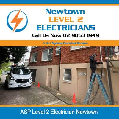 ASP level 2 electrician on ladder working at residential property with service van parked in  Newtown