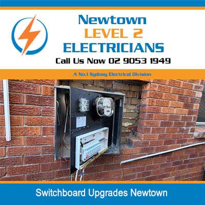 Open electrical switchboard upgrade mounted on brick wall showing circuit breakers and meter in Newtown
